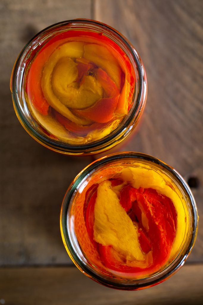 Overhead view of jarred roasted bell peppers.