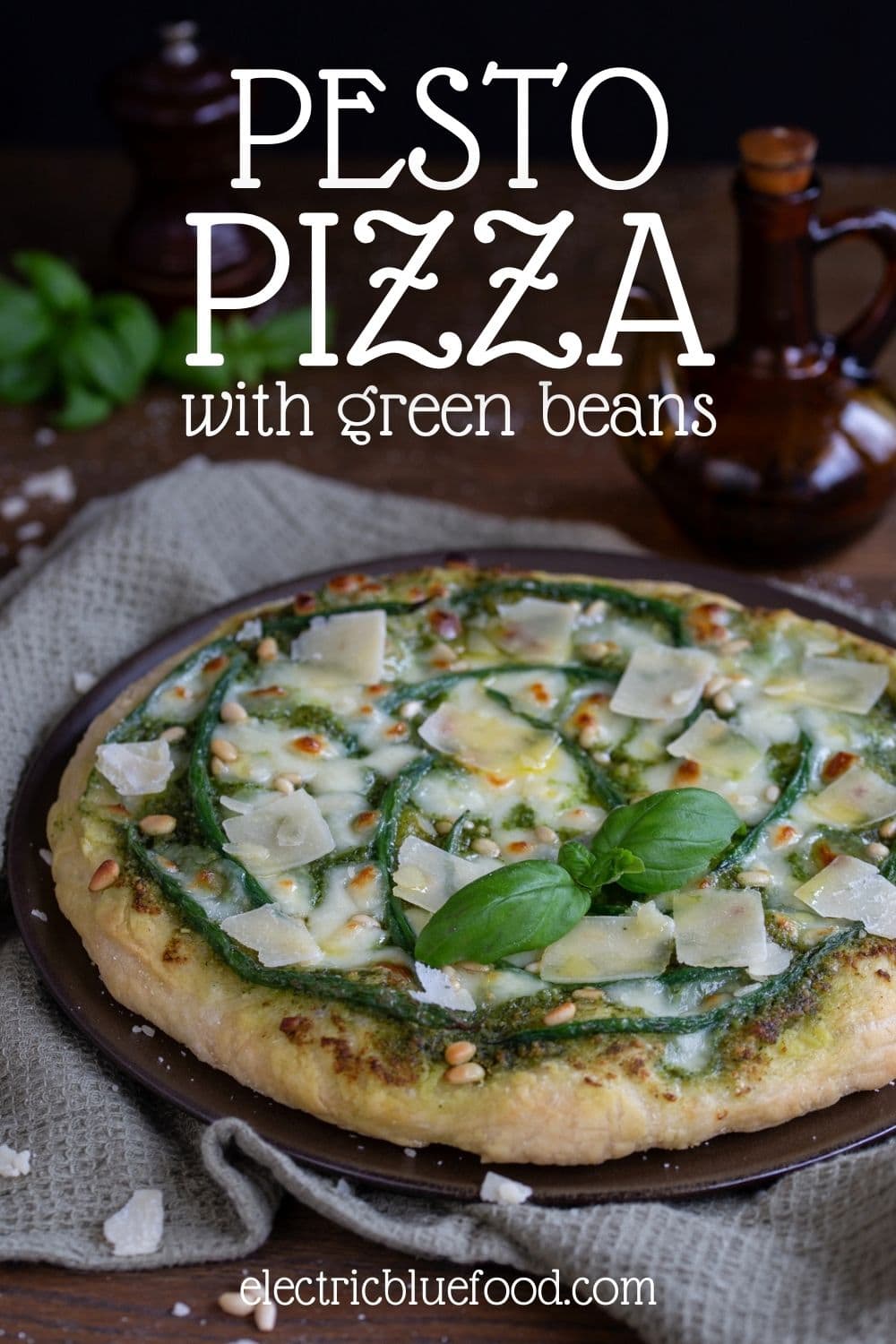 Pesto pizza with green beans is inspired by classic pasta al pesto from Liguria. It is topped with parmesan flakes and pine nuts for a fantastic flavour in this vegetarian pizza without tomato sauce.