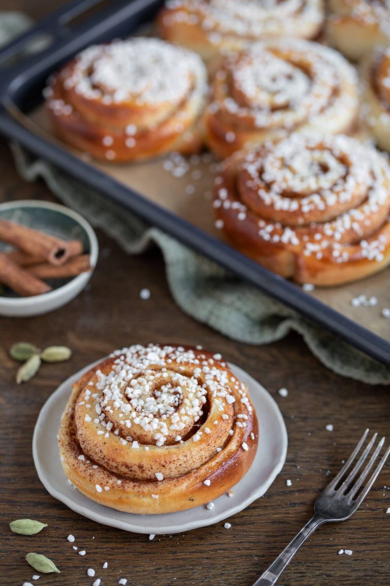 Swedish cinnamon bun on a small white plate.