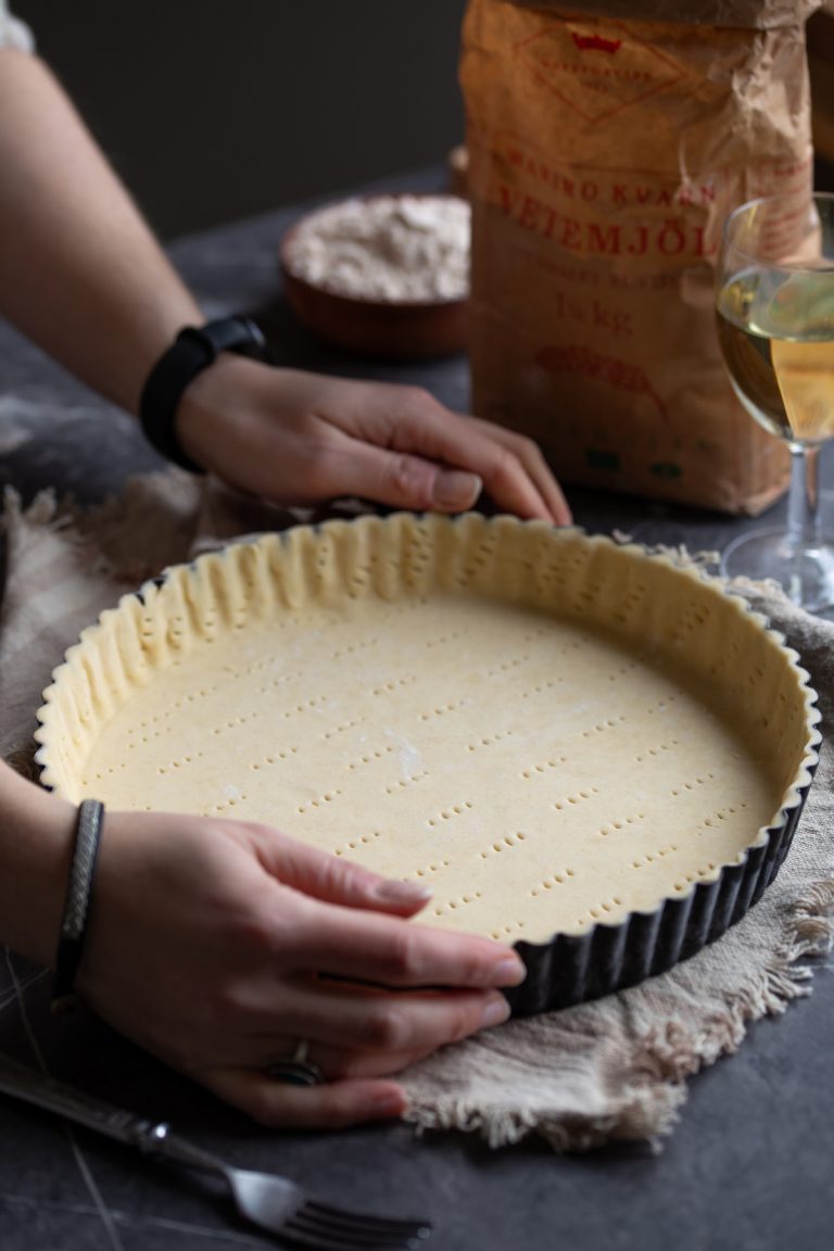 Homemade pie crust pressed onto a baking tin.