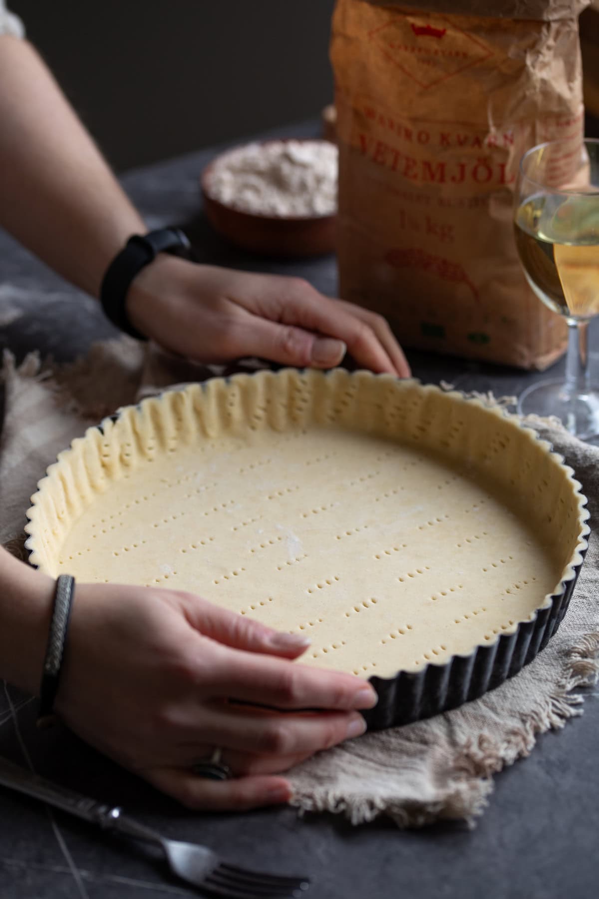 Homemade pie crust pressed onto a baking tin.