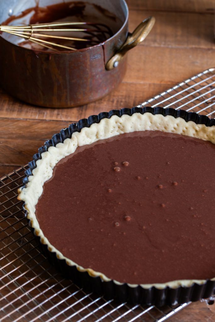 Chocolate filling added to pie crust.