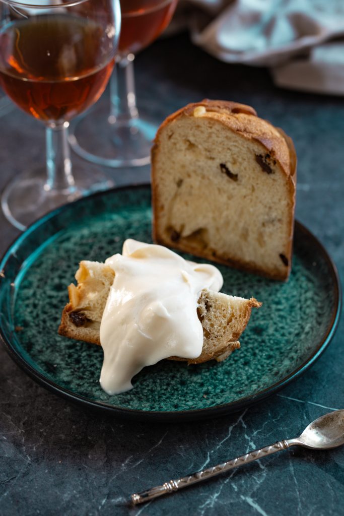 Mini panettone sliced in half, topped with mascarpone cream.