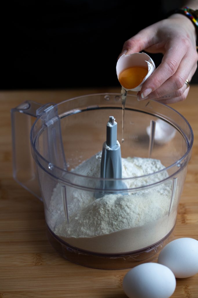 Adding an egg to flour mix.