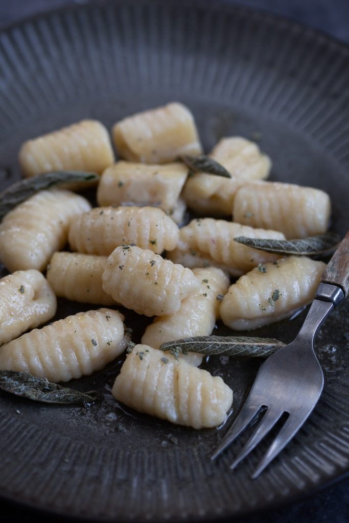 Cooked ricotta gnocchi served with butter and sage.