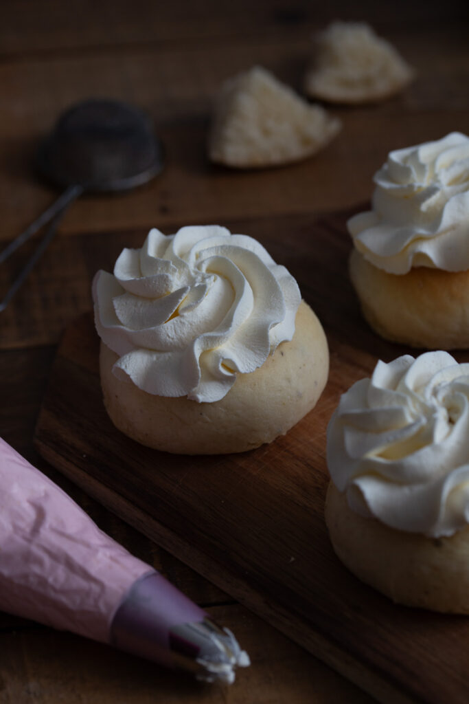 Whipped cream piped on buns.