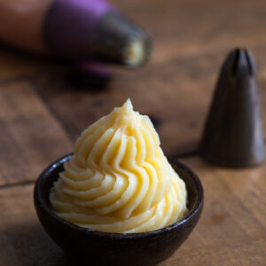 Vanilla custard piped into a small bowl.