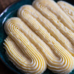 Vanilla custard piped onto a plate with a star tip.