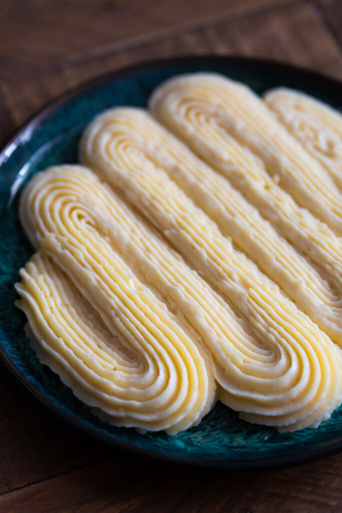 Vanilla custard piped onto a plate with a star tip.