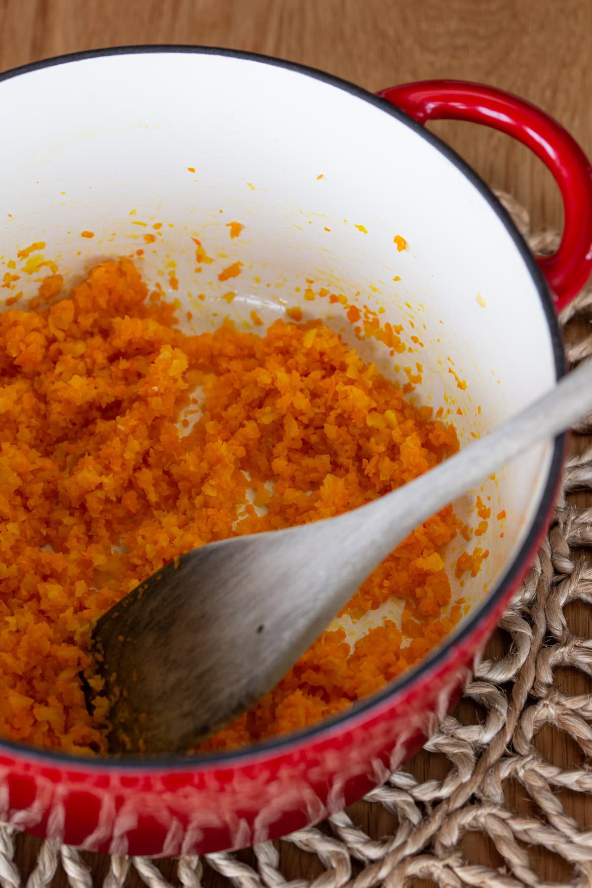 Making a carrot and onion soffritto in a Dutch oven.