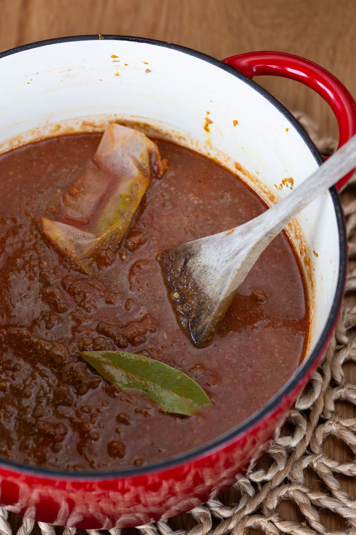 Tomato passata added to meat to make ragu.