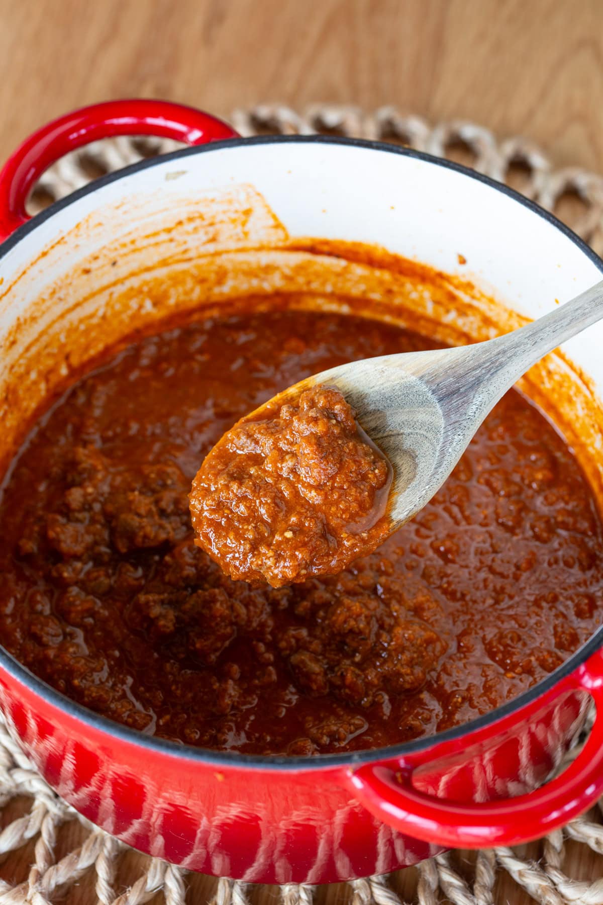Detail of ragu on wooden spoon.
