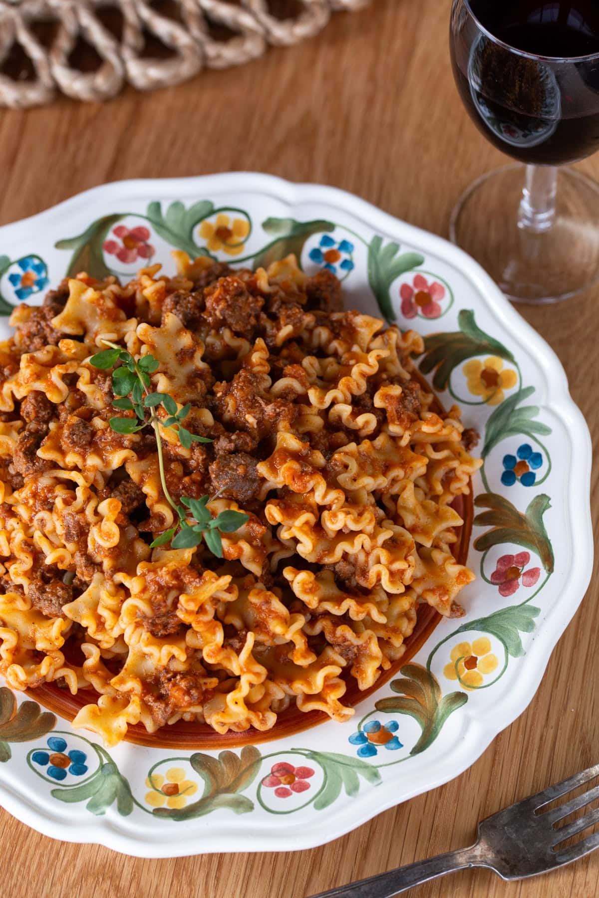 A plate full of pasta with meat sauce.