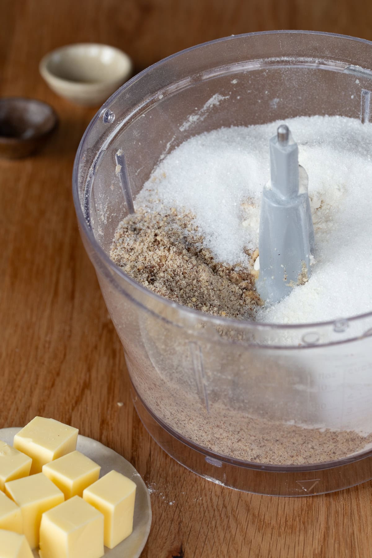 Food processor with ingredients for hazelnut tart crust.