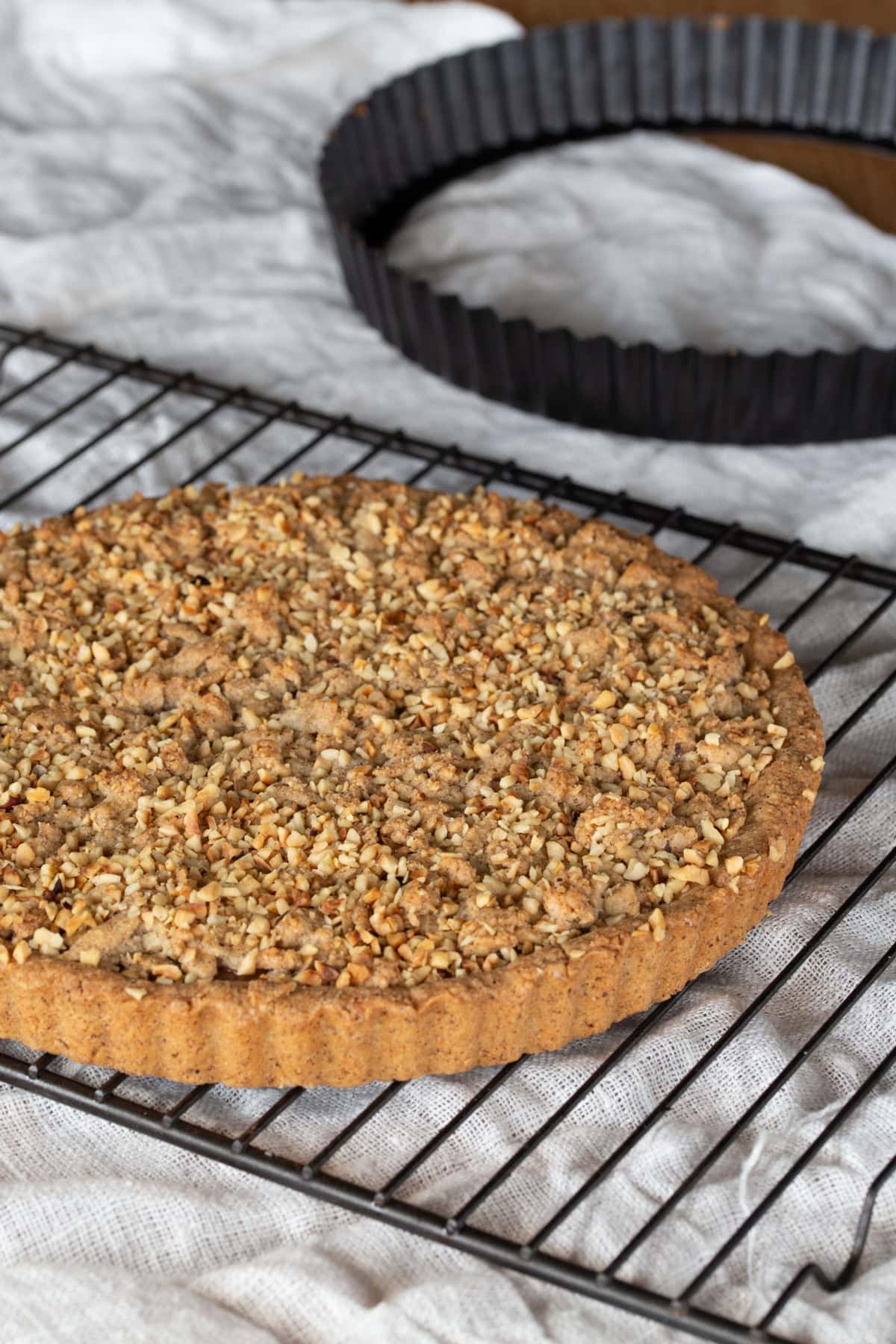 Hazelnut tart on a cooling rack.