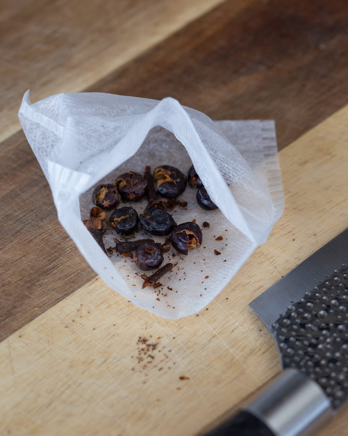 Crushed cloves and juniper berries in a teabag.