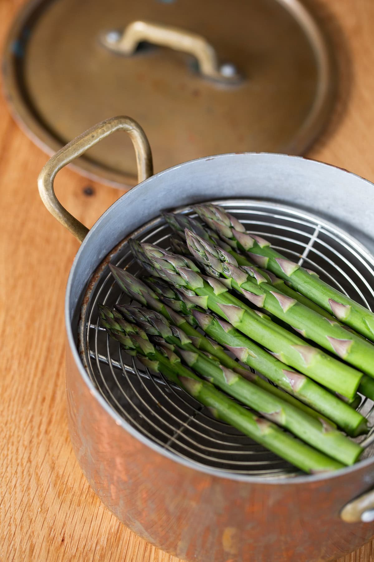 Raw asparagus in a pot to be steamed.