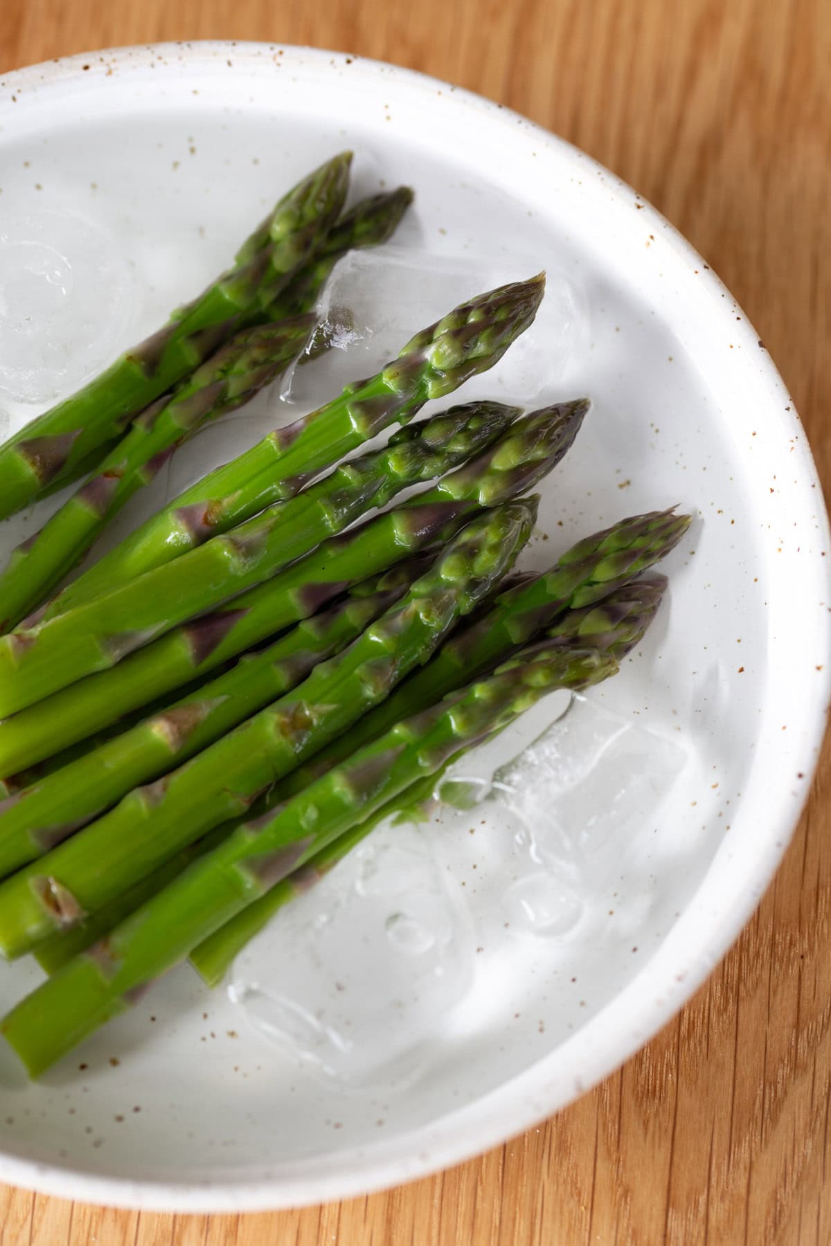Steamed asparagus in ice water.