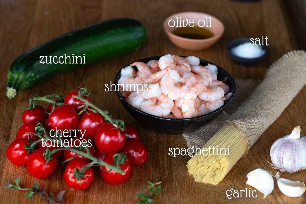Cherry tomato pasta with shrimp and zucchini ingredients.