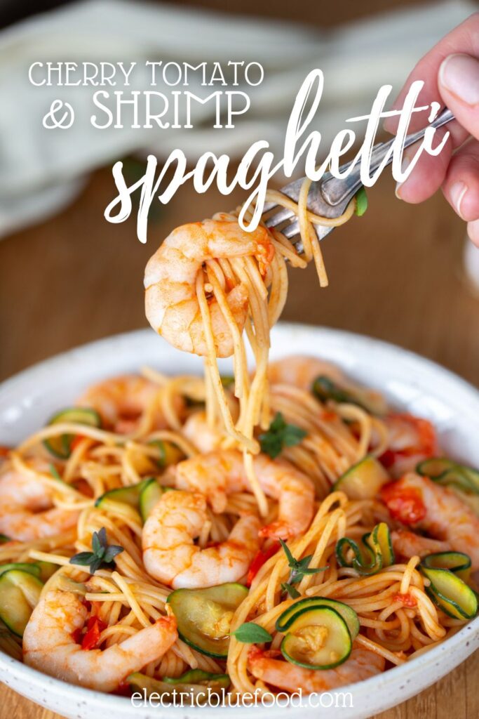 Cherry tomato pasta with shrimp and zucchini pin.