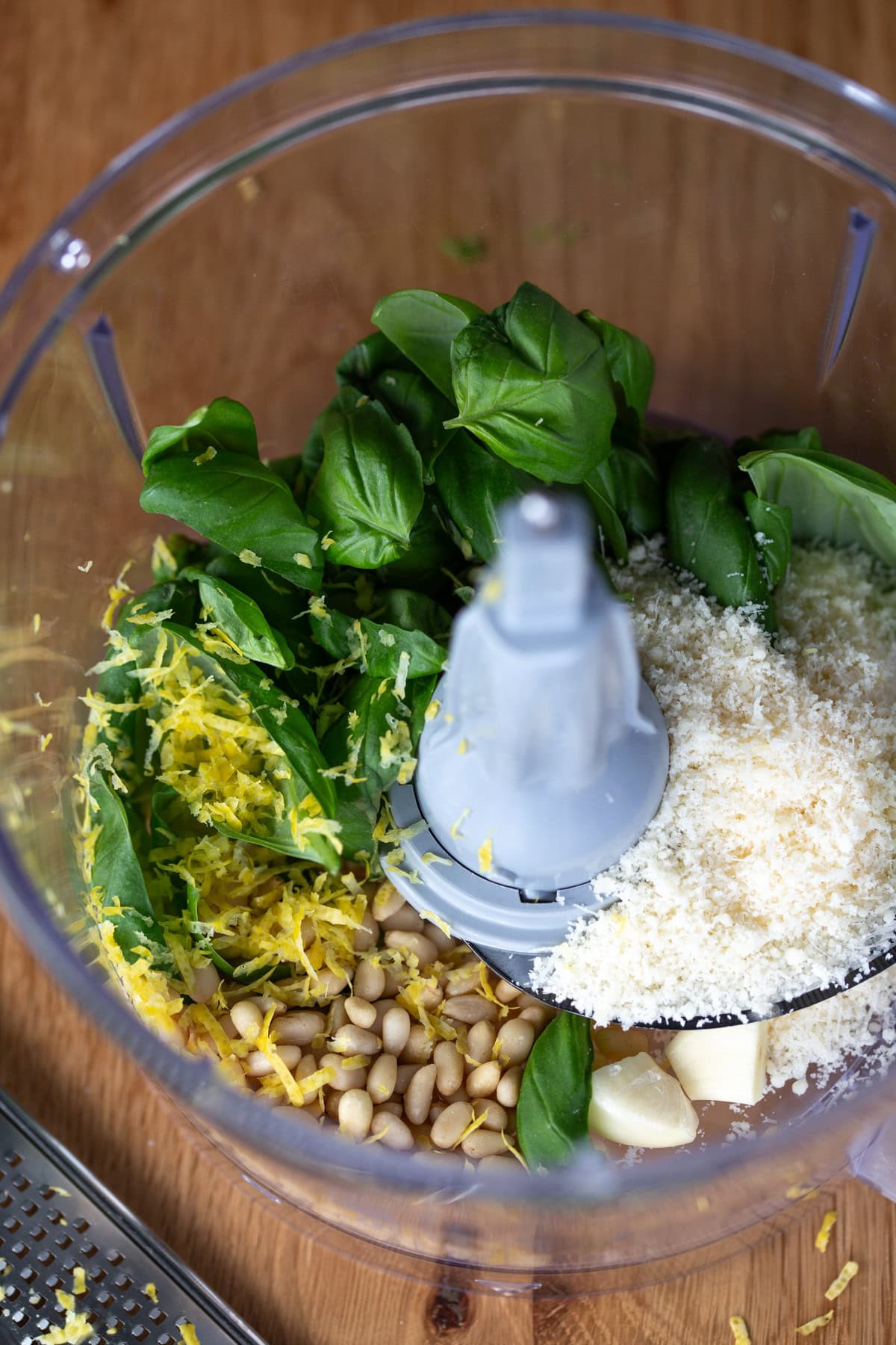 Basil leaves, parmesan, garlic and lemon zest in a food processor.