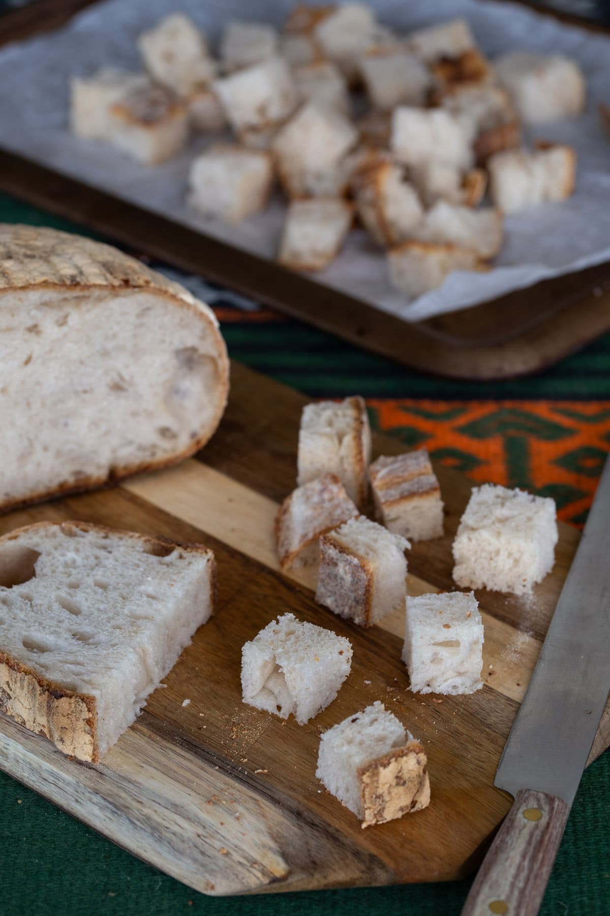 Diced sourdough bread on wooden board.