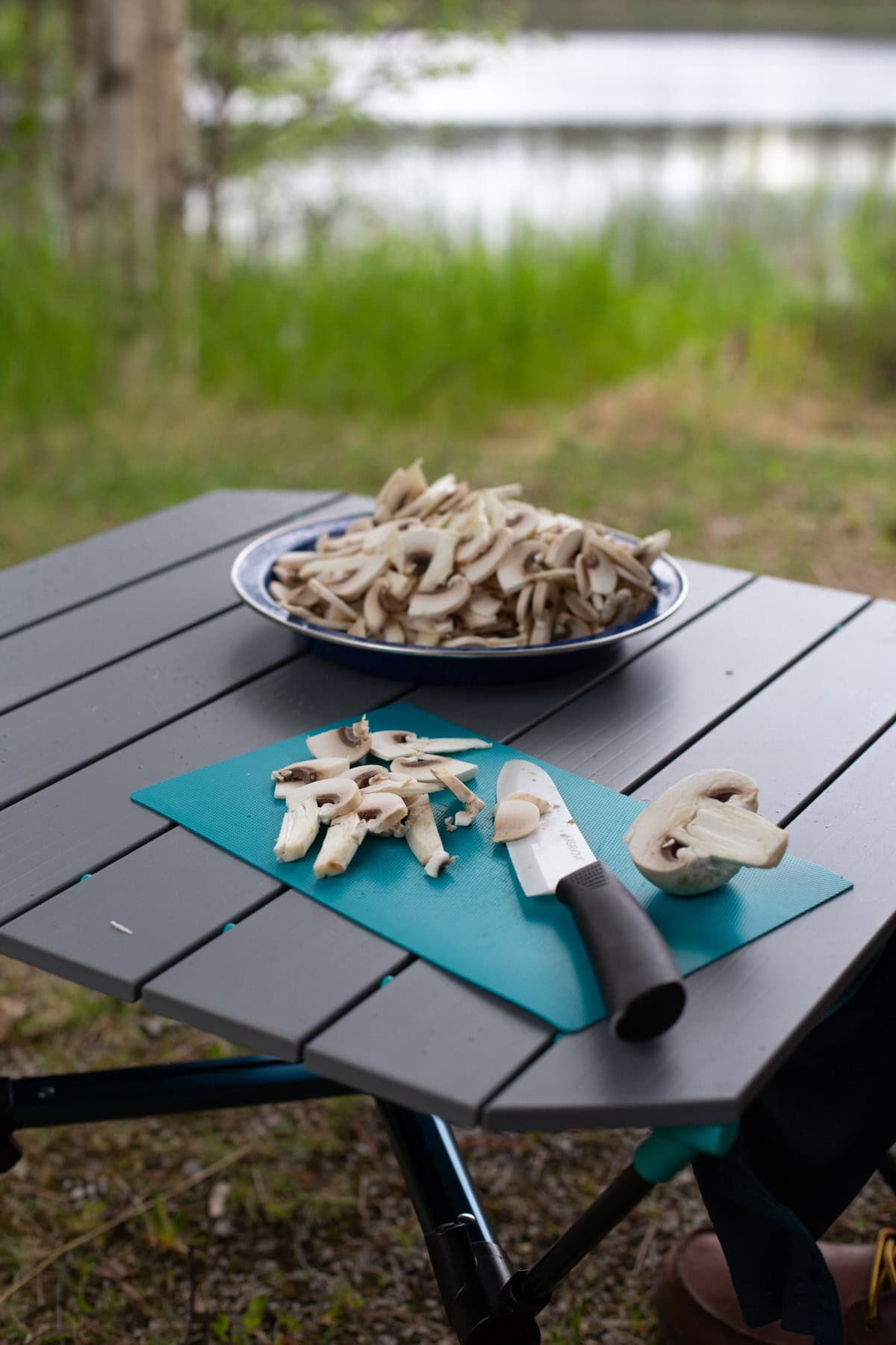 Slicing mushrooms on a plastic board.