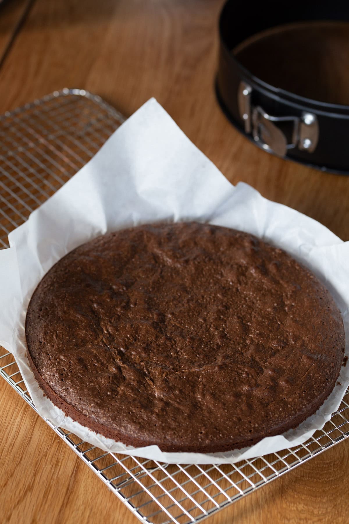 One layer of brownie base baked, on a cooling rack.