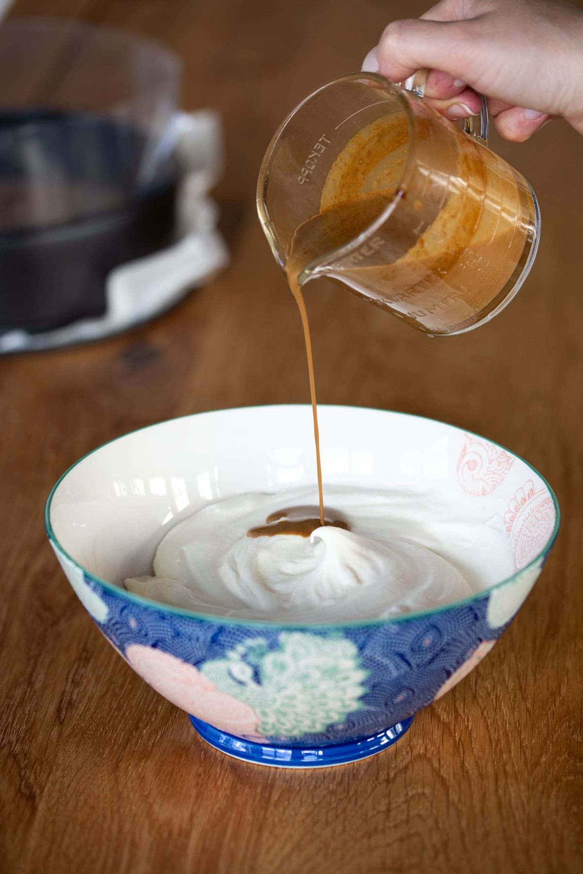 Pouring gelatin cream into whipped cream.