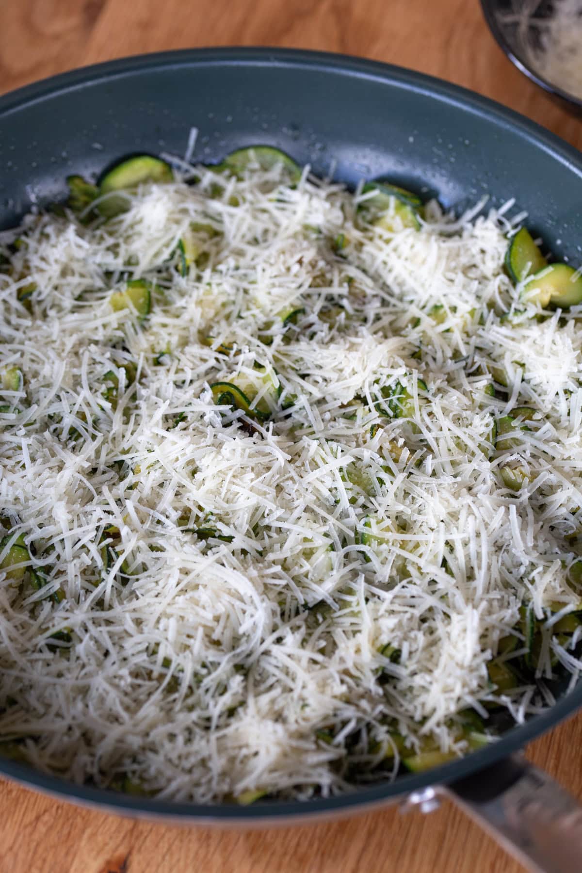 Sauteed zucchini covered with grated parmesan.
