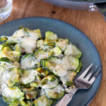 Parmesan zucchini served on a green plate.