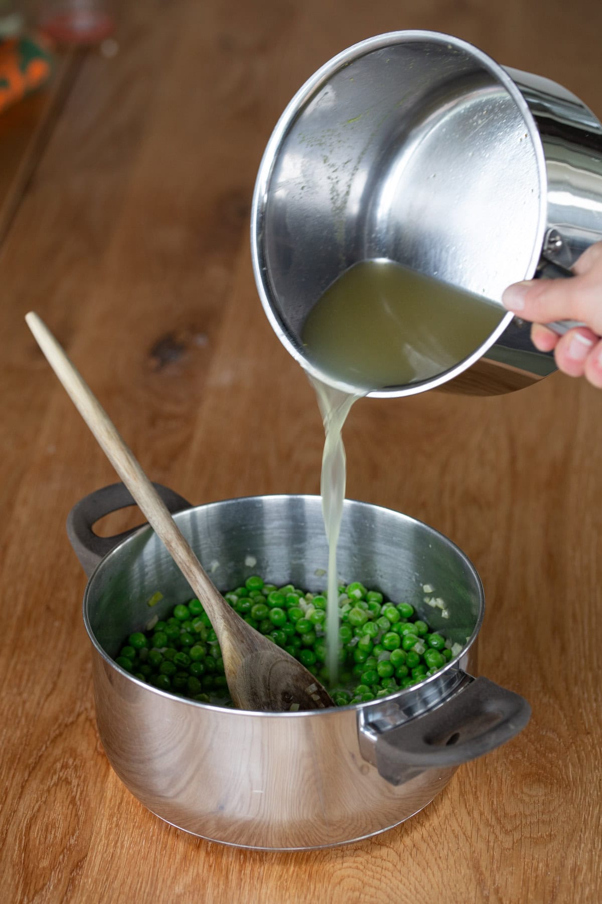 Pouring broth into a pot.