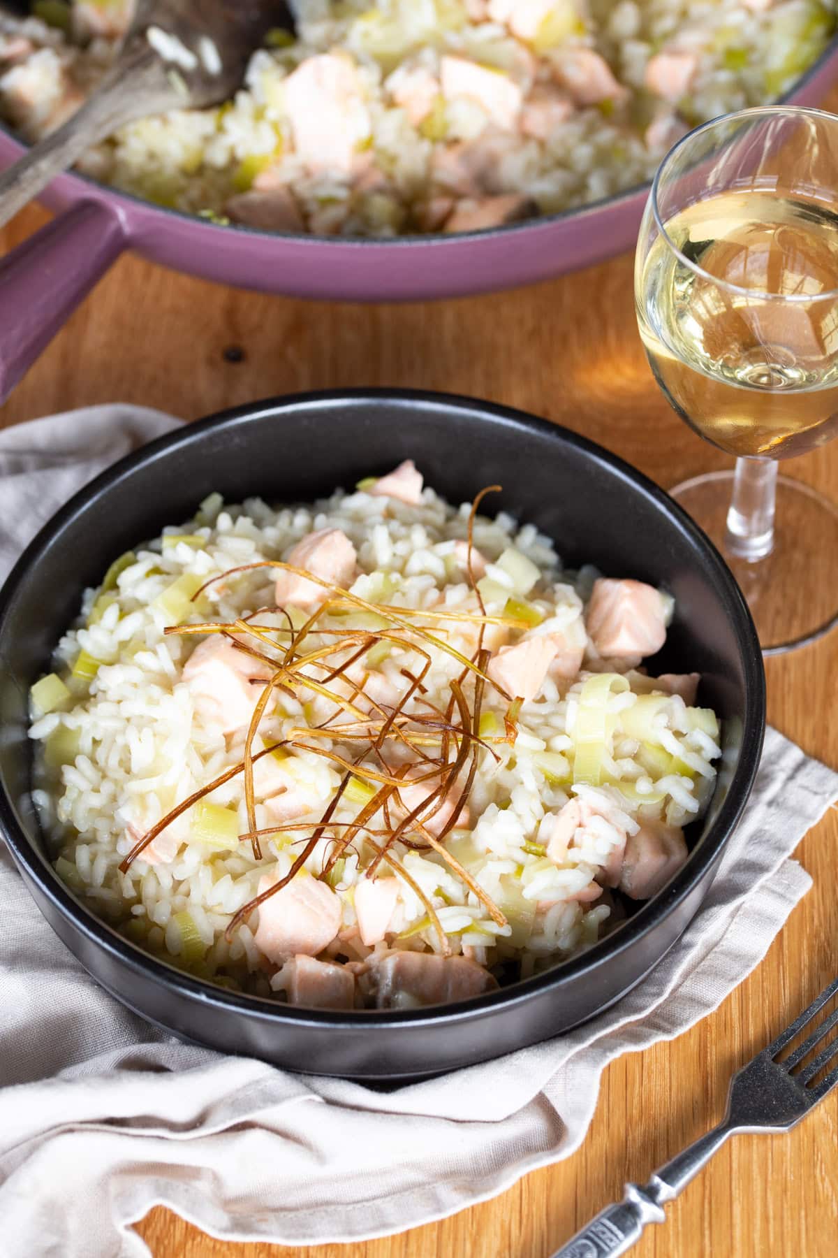 Salmon risotto with fried leek topping.