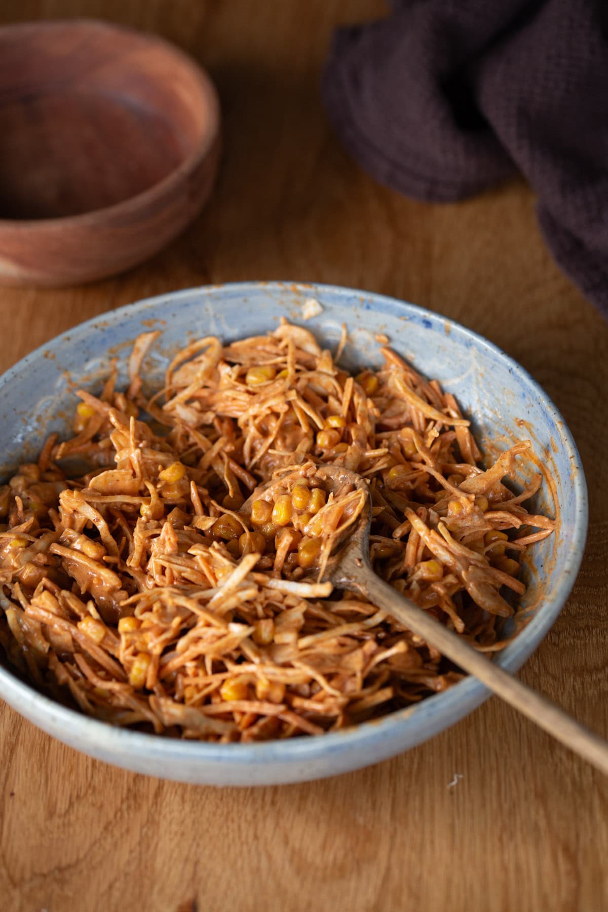 Smokey cornslaw in a blue bowl.