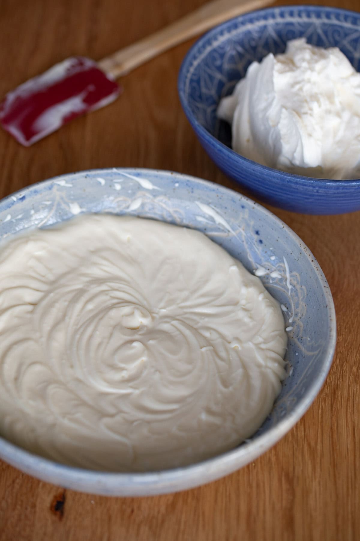 One bowl with whipped cream, one bowl with mascarpone and egg cream.