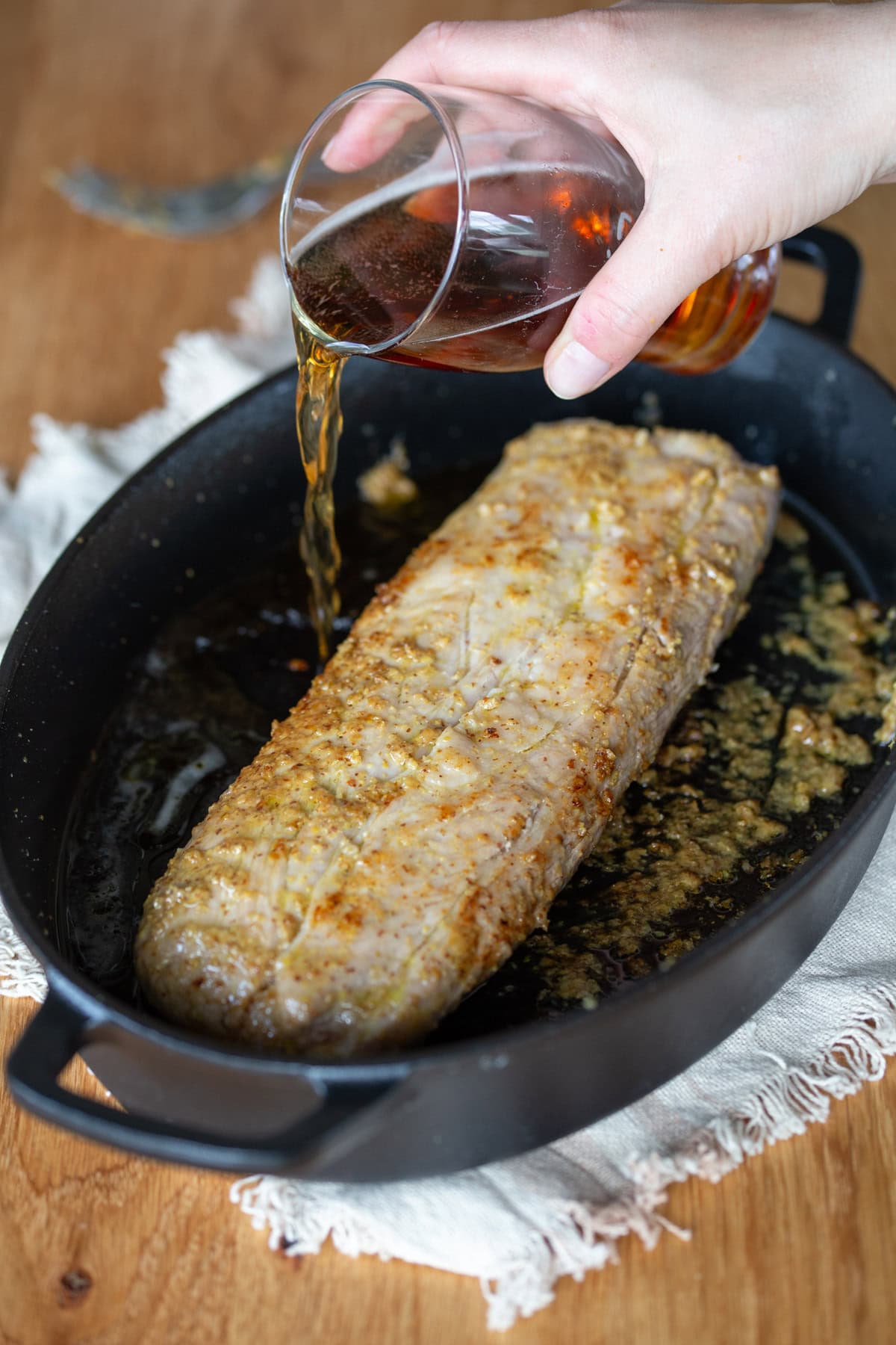 Pouring beer into casserole dish.