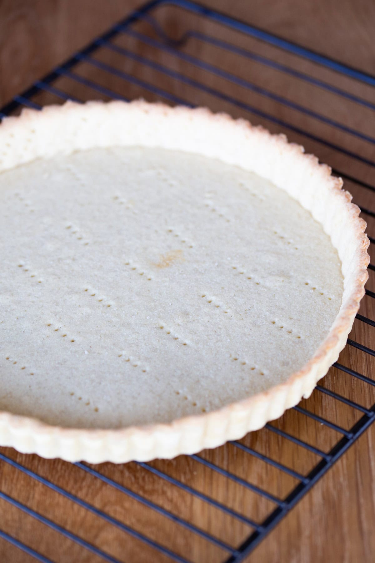 Pre-baked tart shell on a cooling rack.