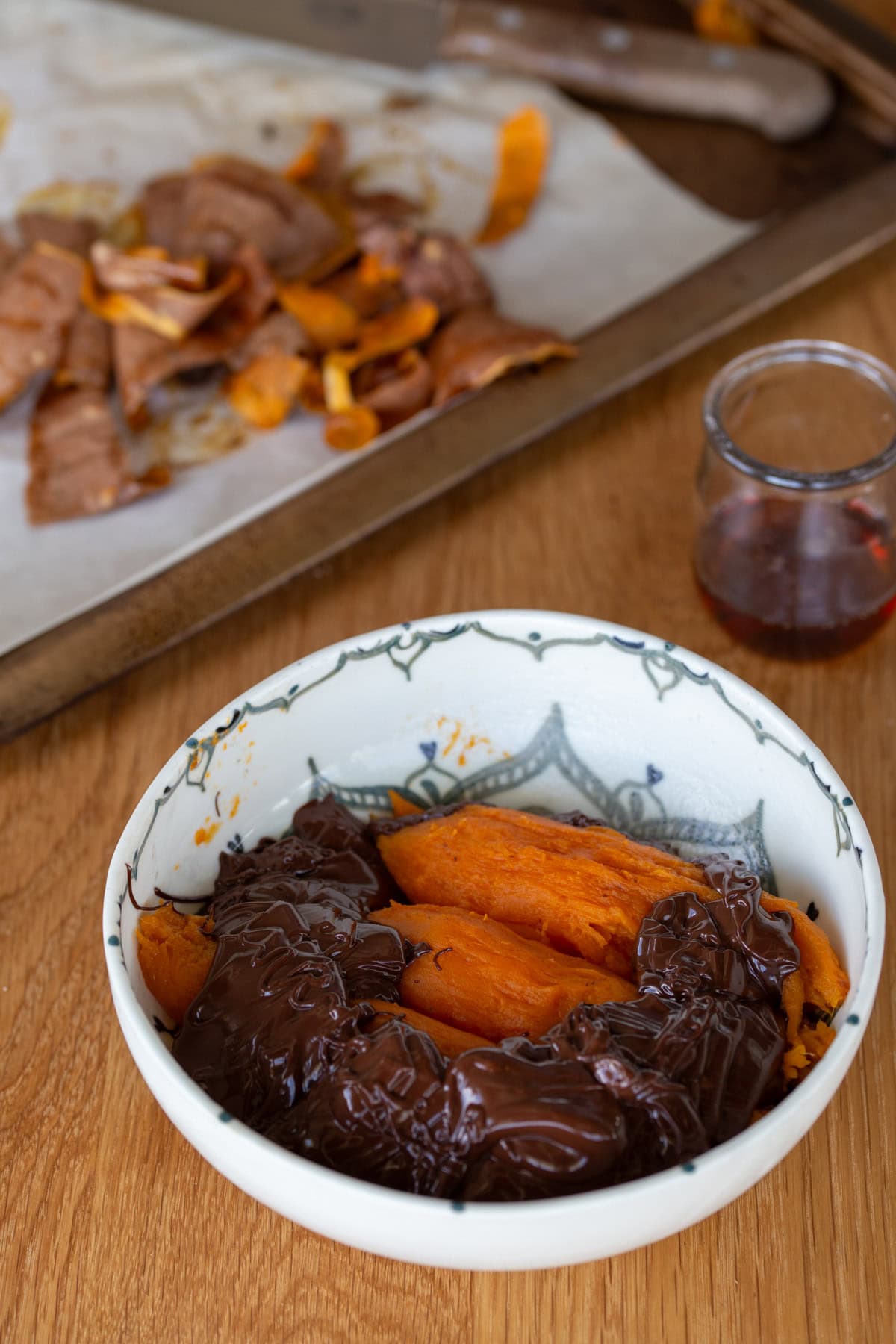 Roasted sweet potatoes and melted chocolate in a bowl.