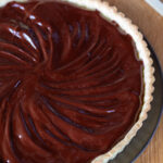 Chocolate sweet potato tart topped with a layer of chocolate and coconut oil.
