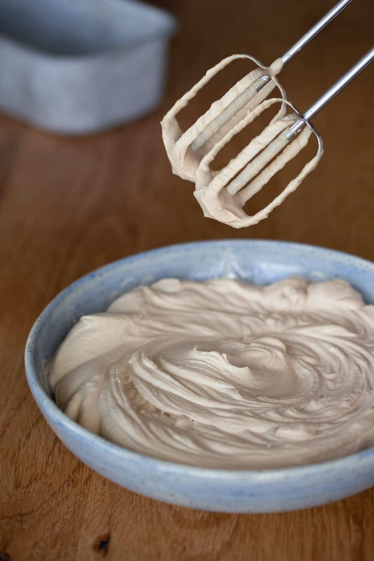 Whipped coffee flavoured craem in a light blue bowl.