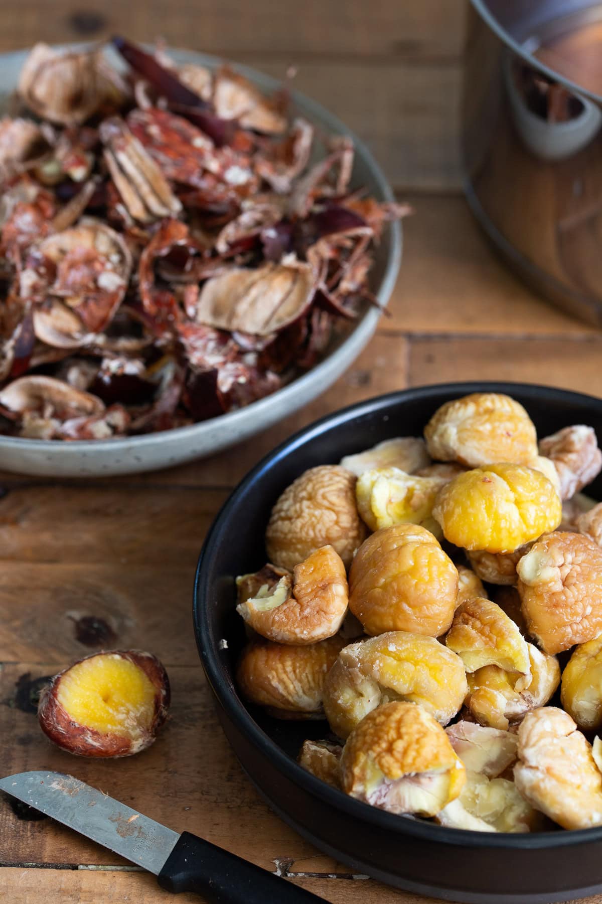 Peeled chestnuts, peels in the background.