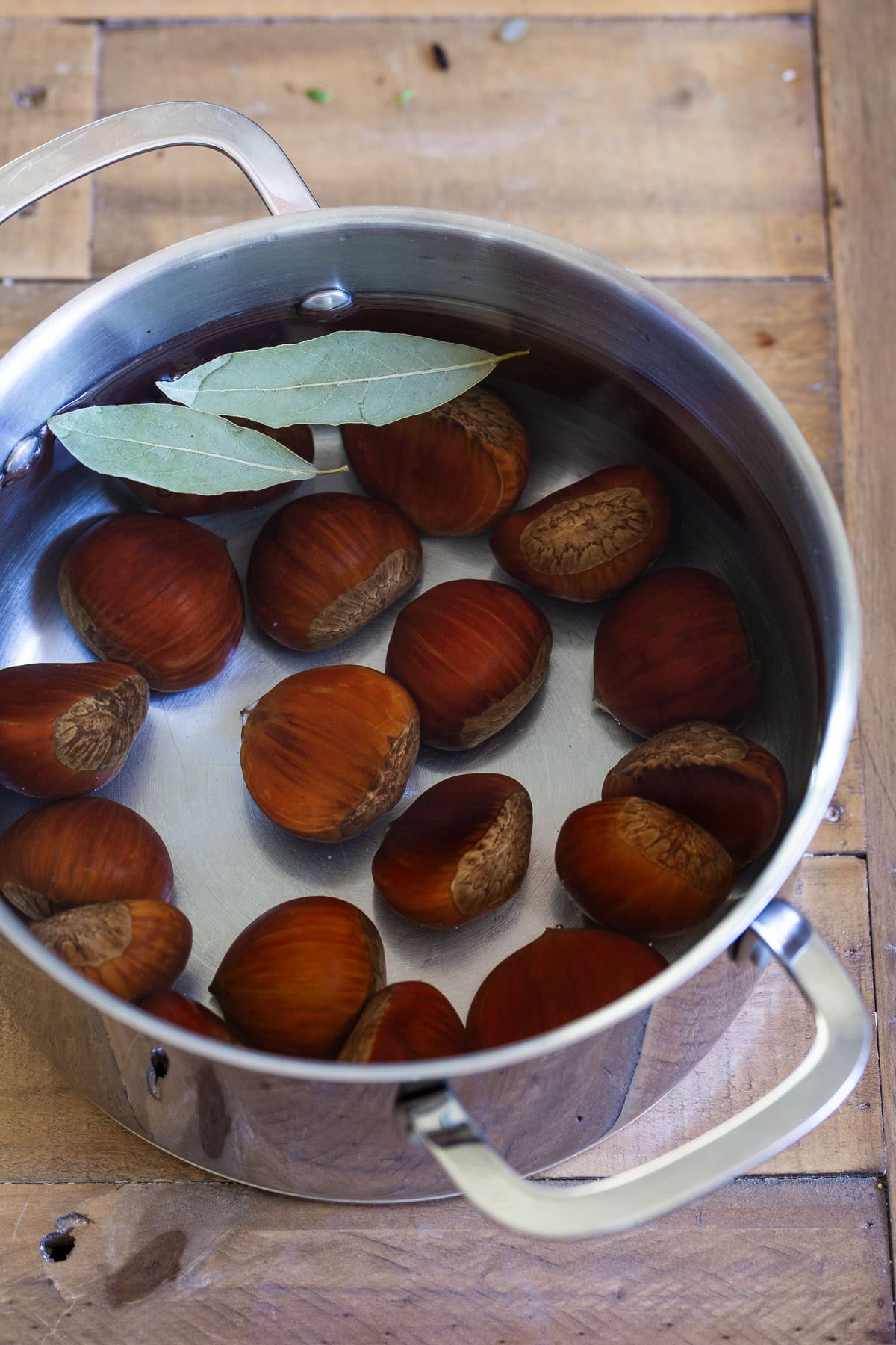 Chestnuts in a pot with water and bay leaves.