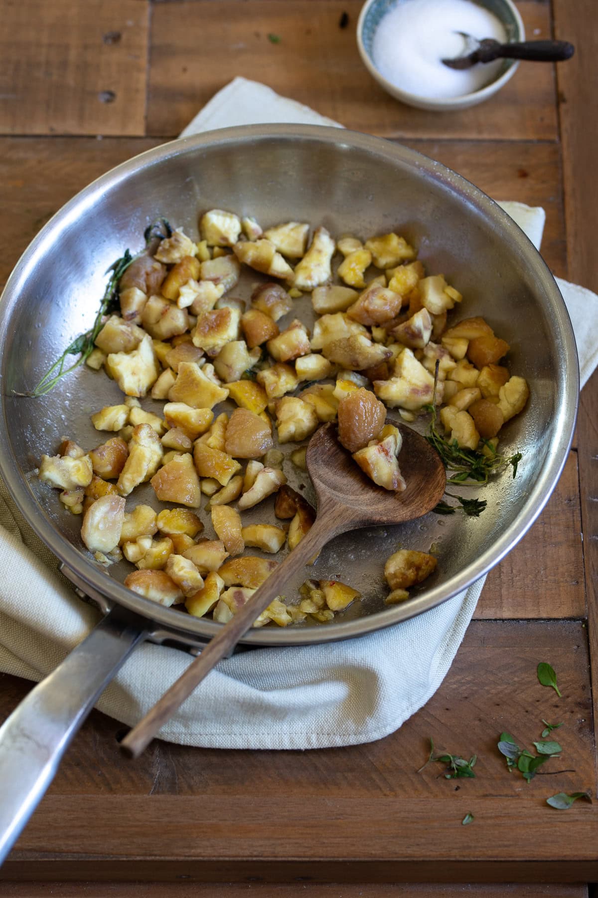 Sautéeing chestnuts in a small skillet.