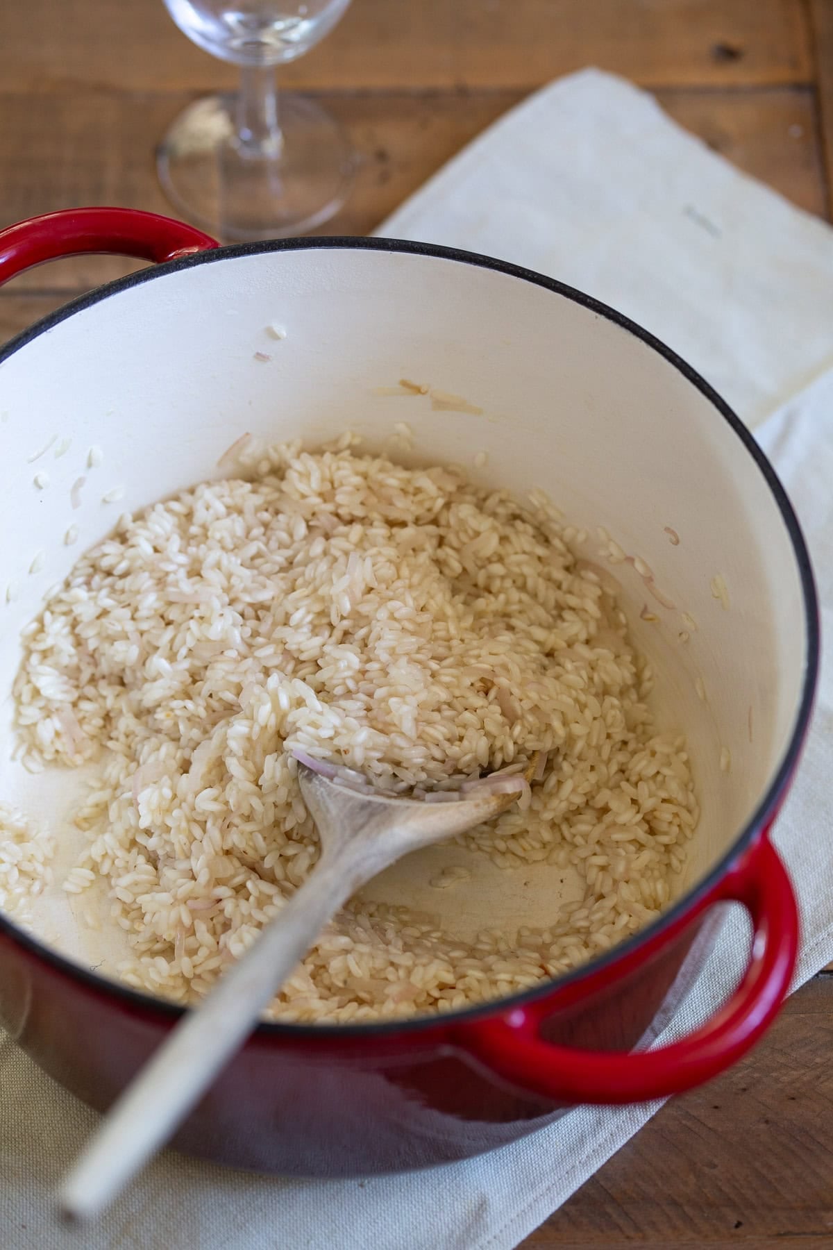 Toasting risotto rice in a Dutch oven pot.