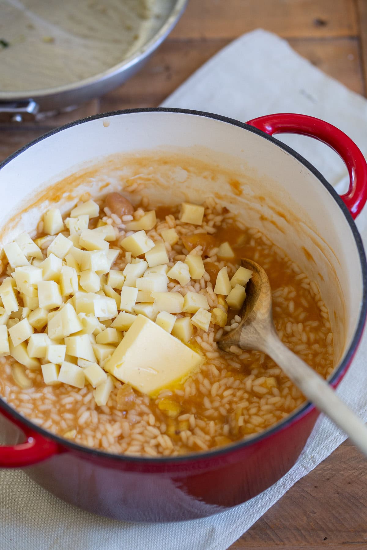 Diced cheese and butter folded into risotto.