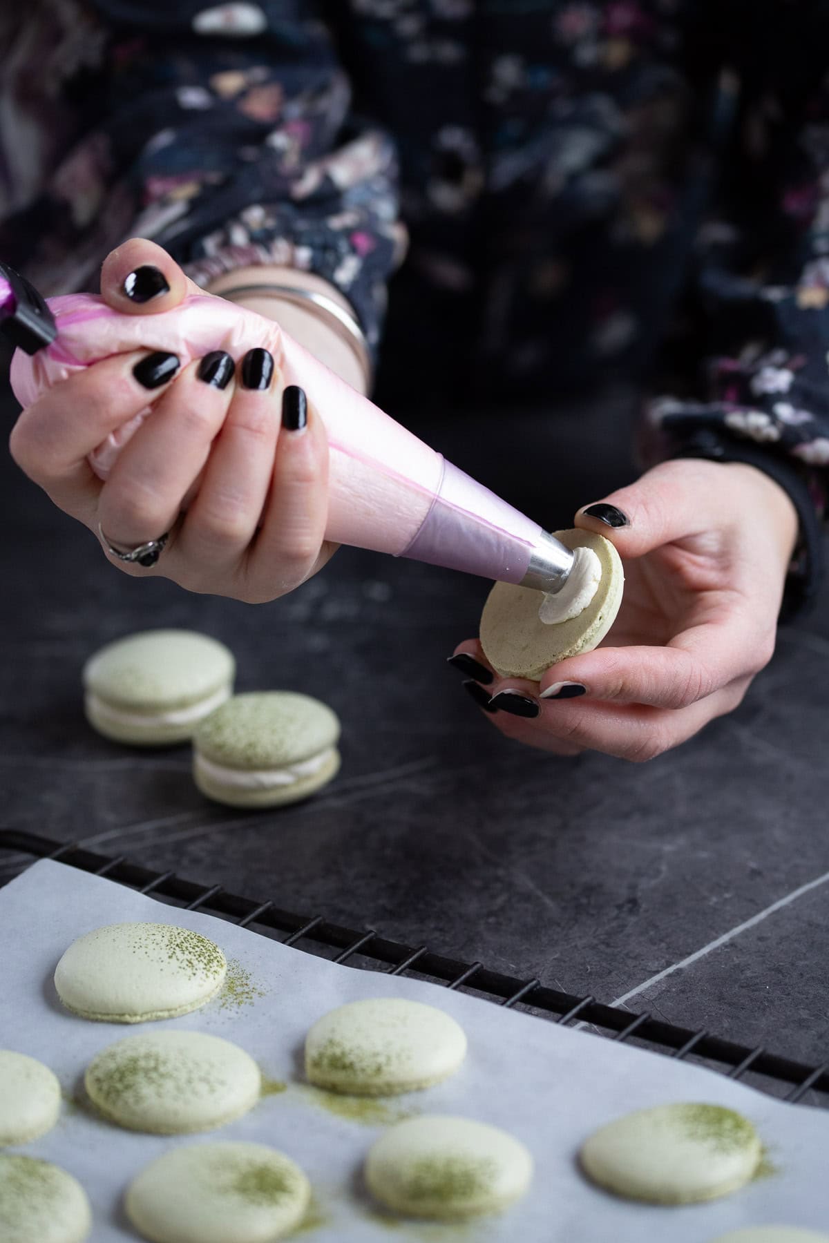 Filling macaron with buttercream.